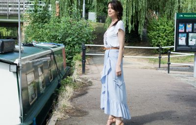 blue-pinstriped-cotton-skirt-raffia-clutch-bag